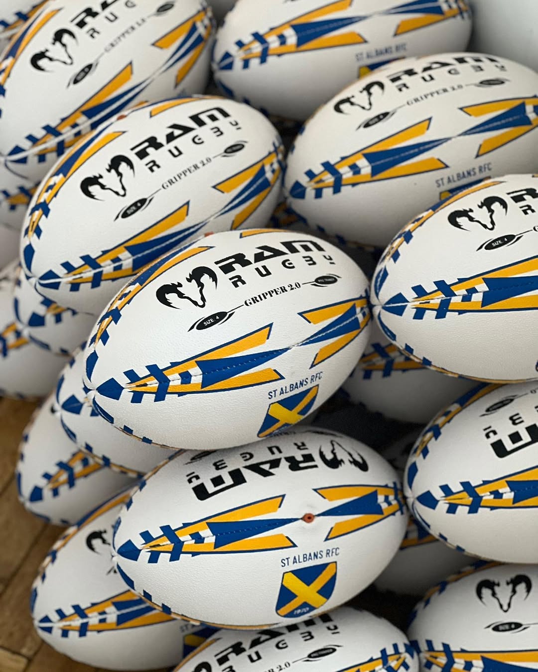 Cleaning a muddy rugby ball with a damp cloth