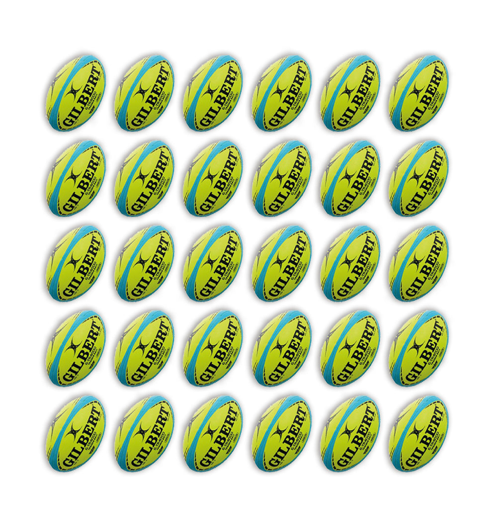 Stack of 30 Gilbert G-TR4000 trainer rugby balls in white and green with 2 black breathable ball bags for size 5 balls